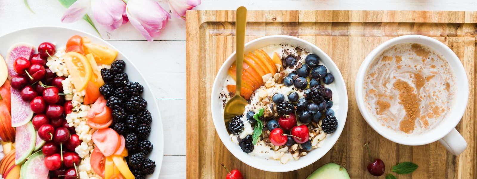 black and red cherries on white bowl